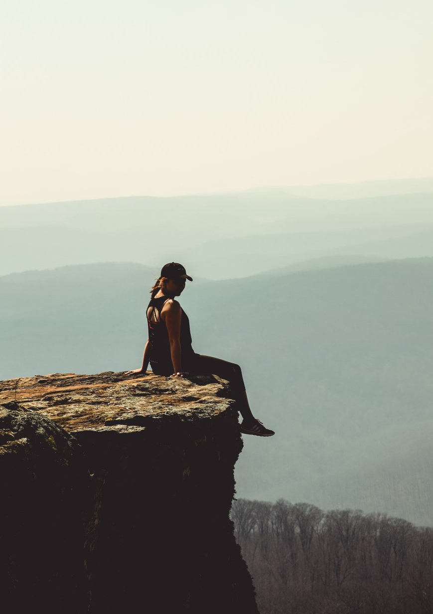 Woman sitting on a rock
