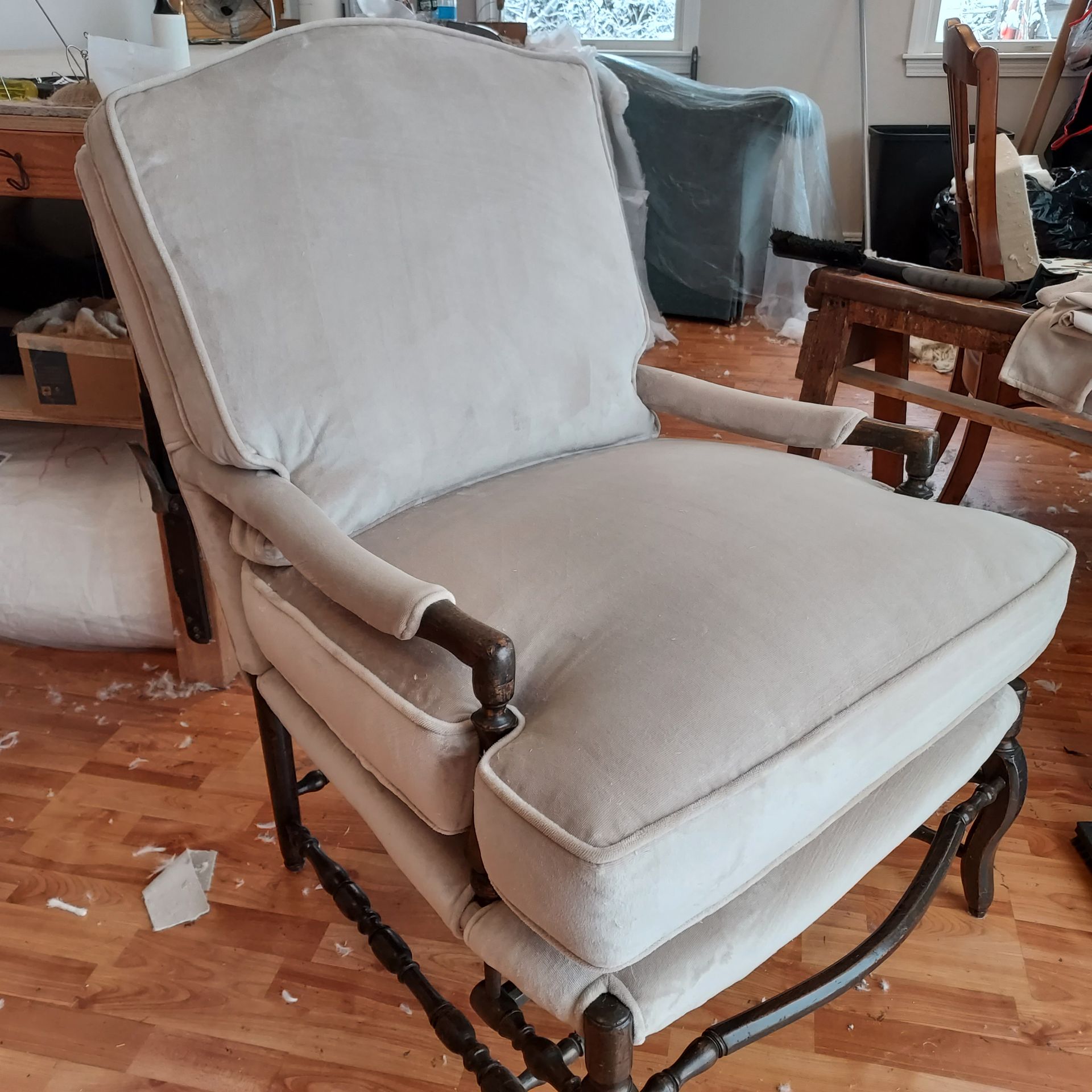A chair with a pattern on it is sitting on a wooden floor.