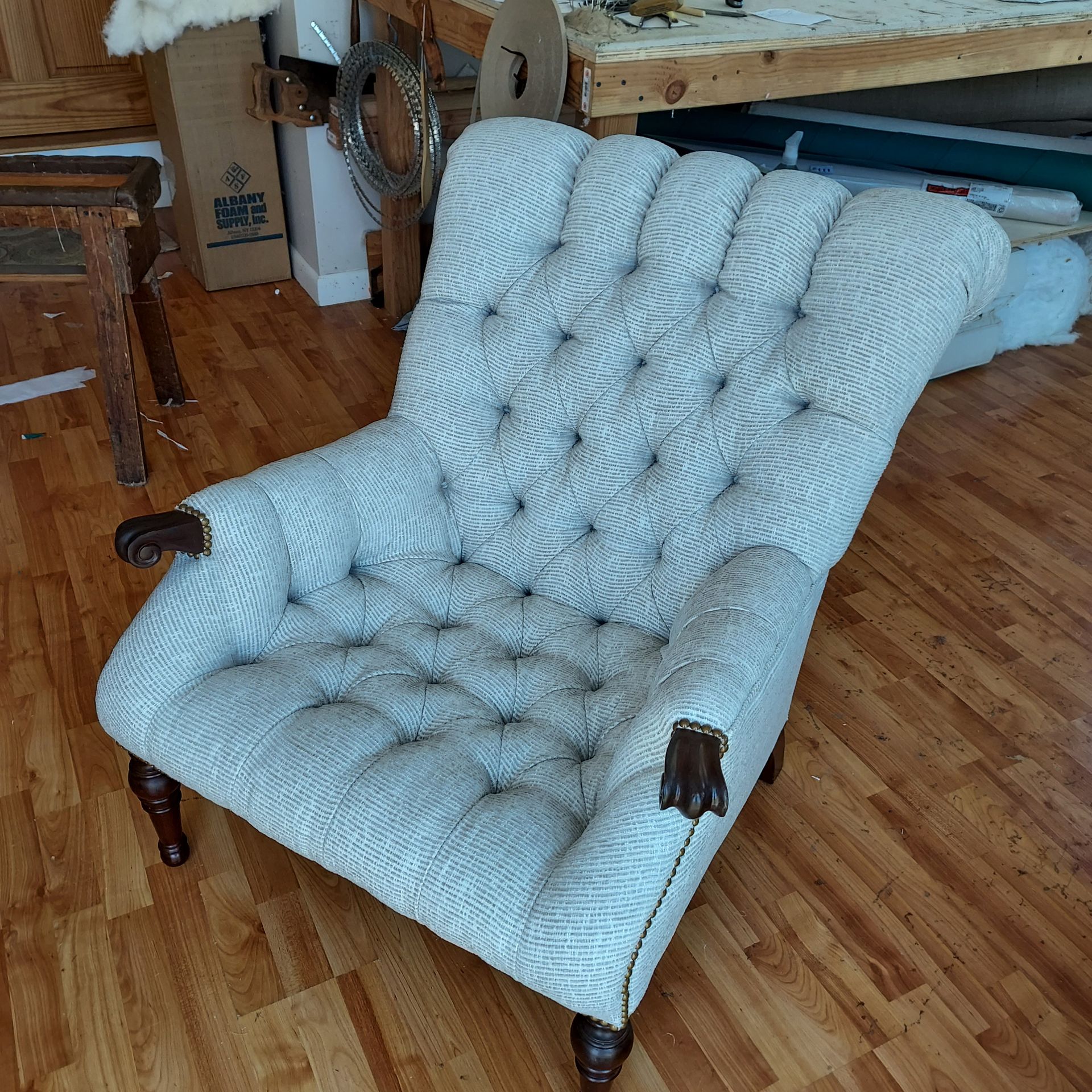 A couch with pillows on it is sitting on a rug in a living room.