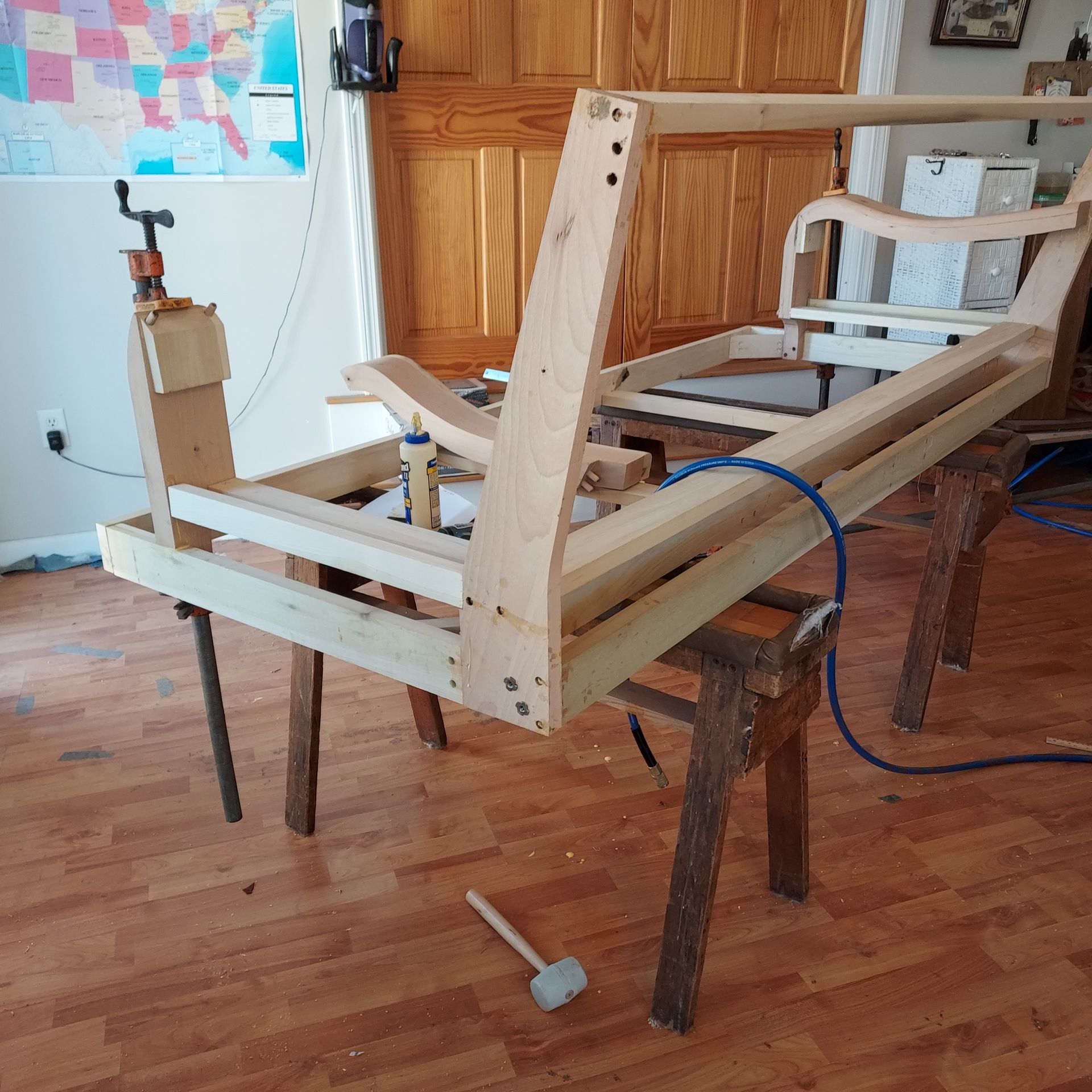 A wooden chair is being built on a wooden floor.