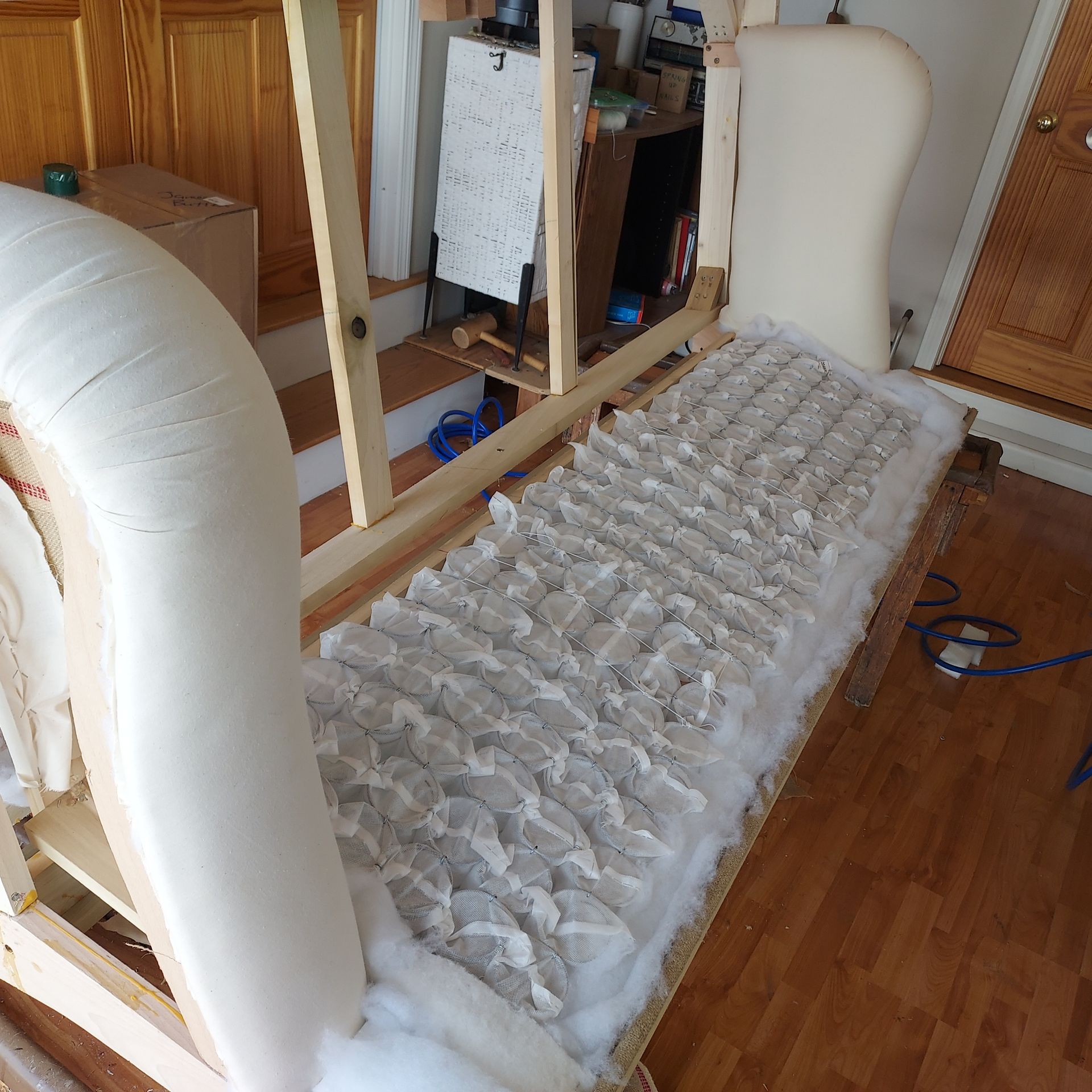 A white couch is being built in a living room