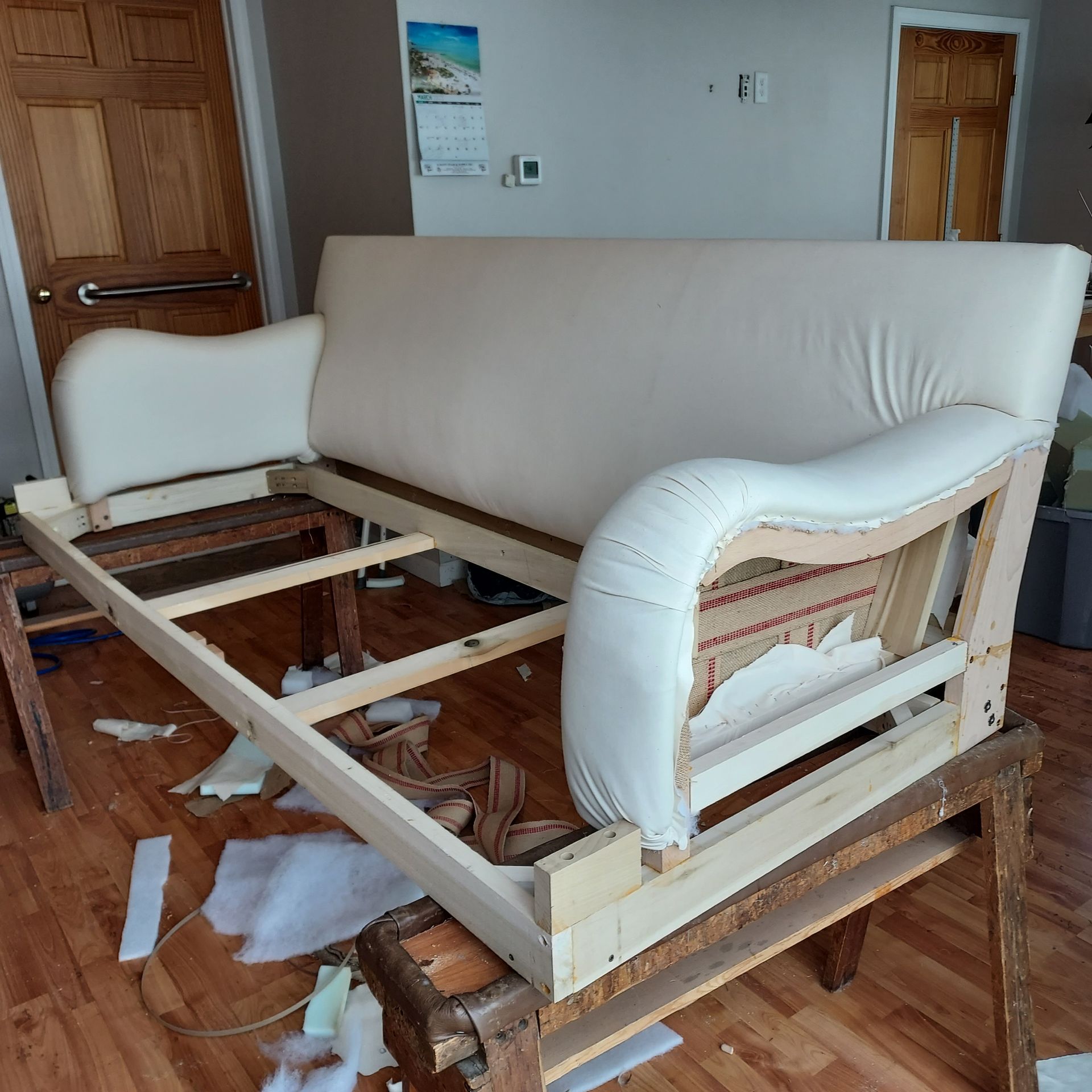 A couch is being built in a living room.