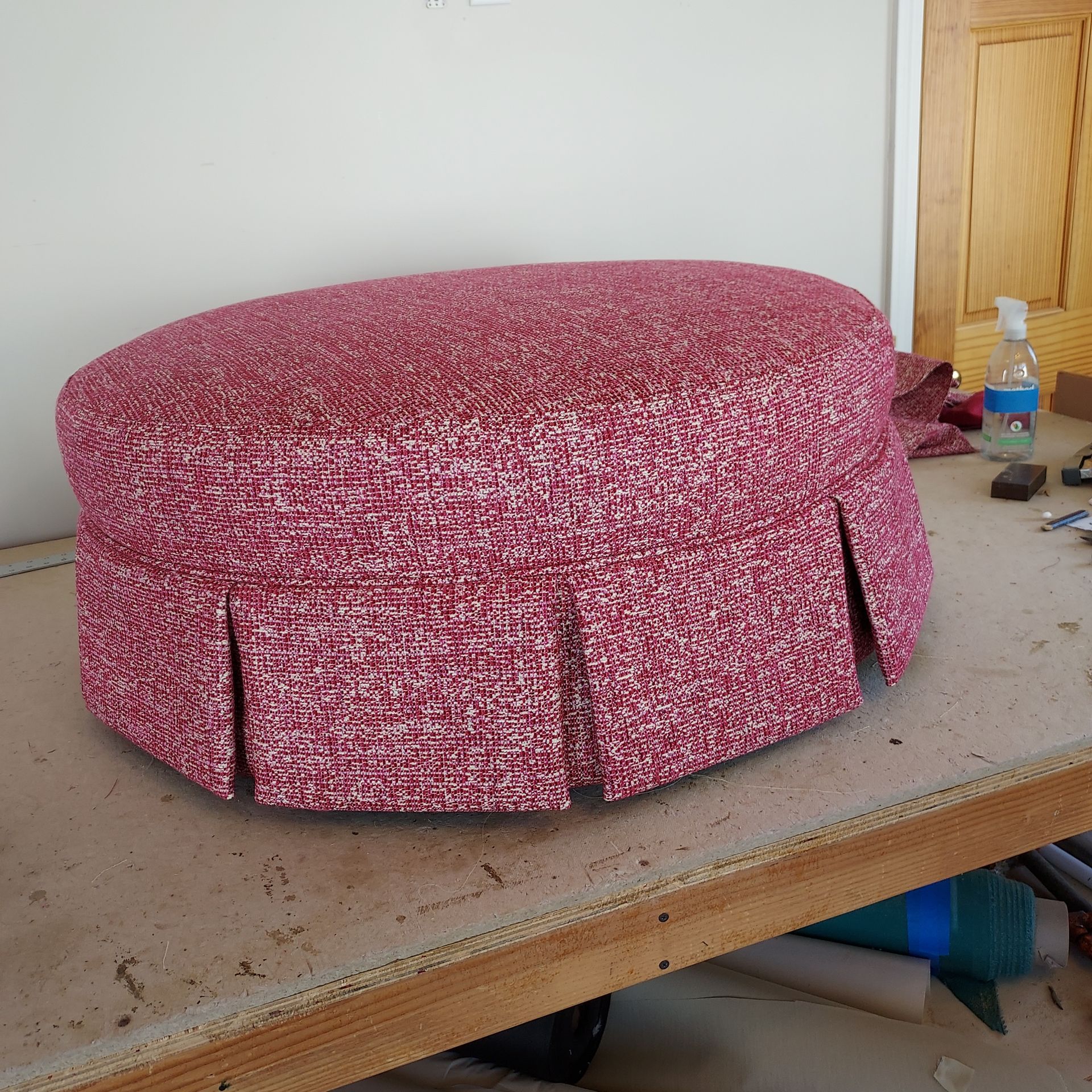 A pink couch is sitting on a pink rug in a room.