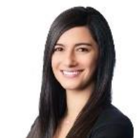 Smiling woman with long dark hair wearing a black blazer against a white background