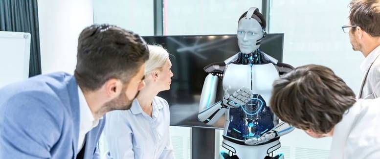 A group of people are looking at a robot.