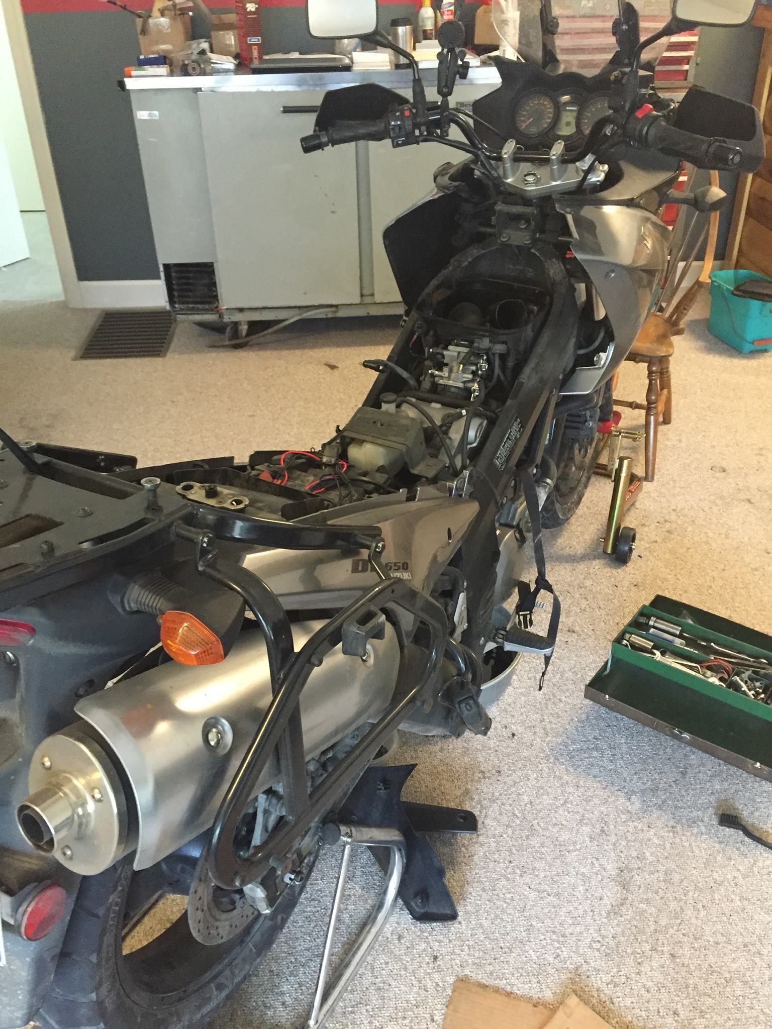 A motorcycle is sitting on the floor in a room.