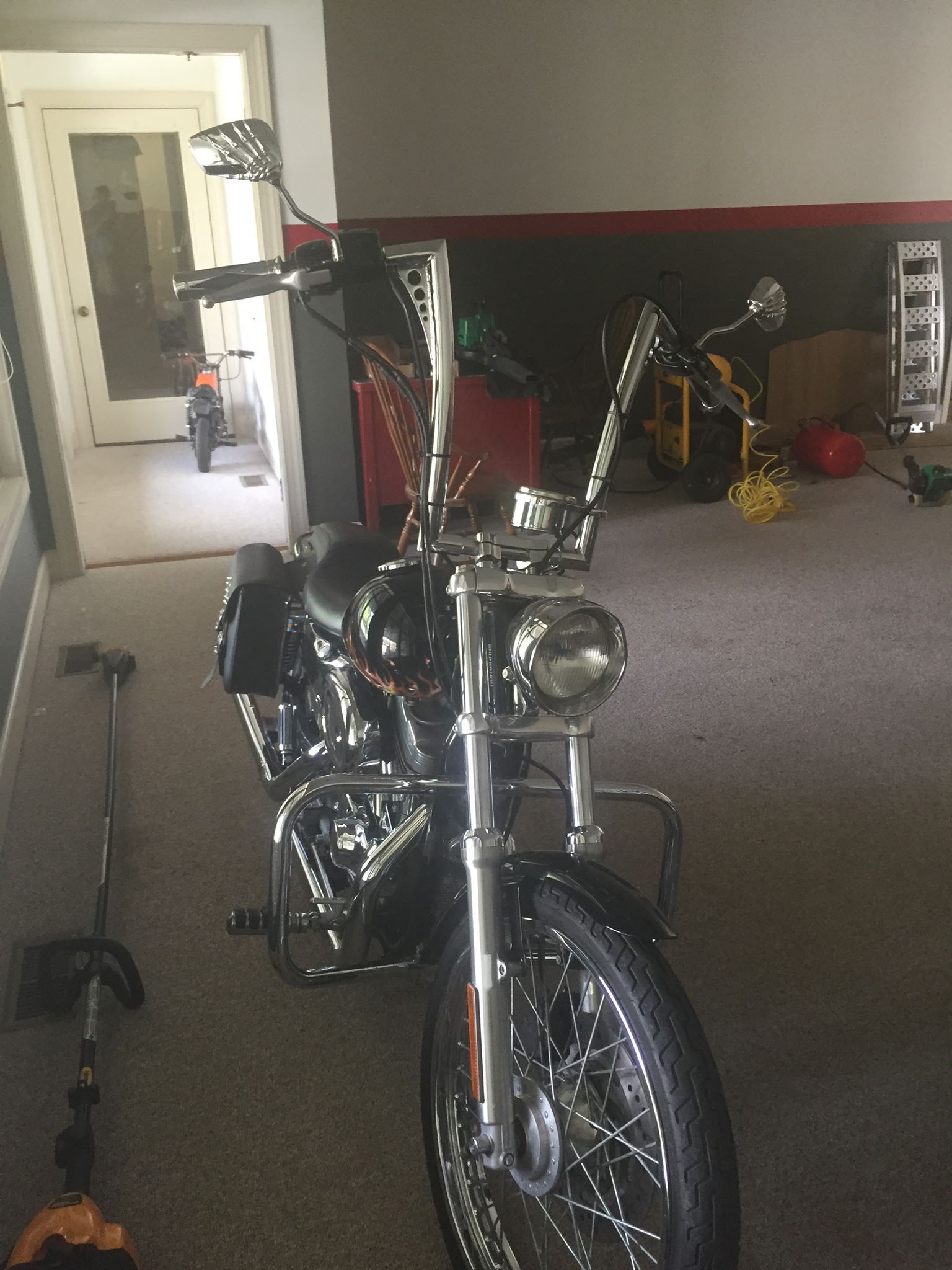 A motorcycle is parked in a room in a garage.