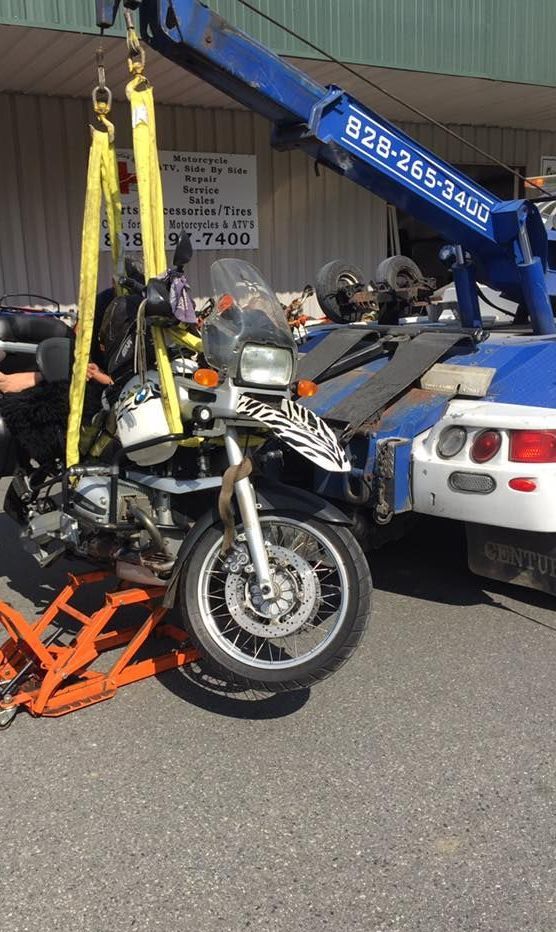 A motorcycle is being towed by a tow truck.