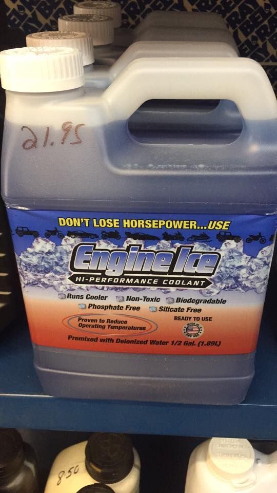 A gallon of engine coolant is on a shelf