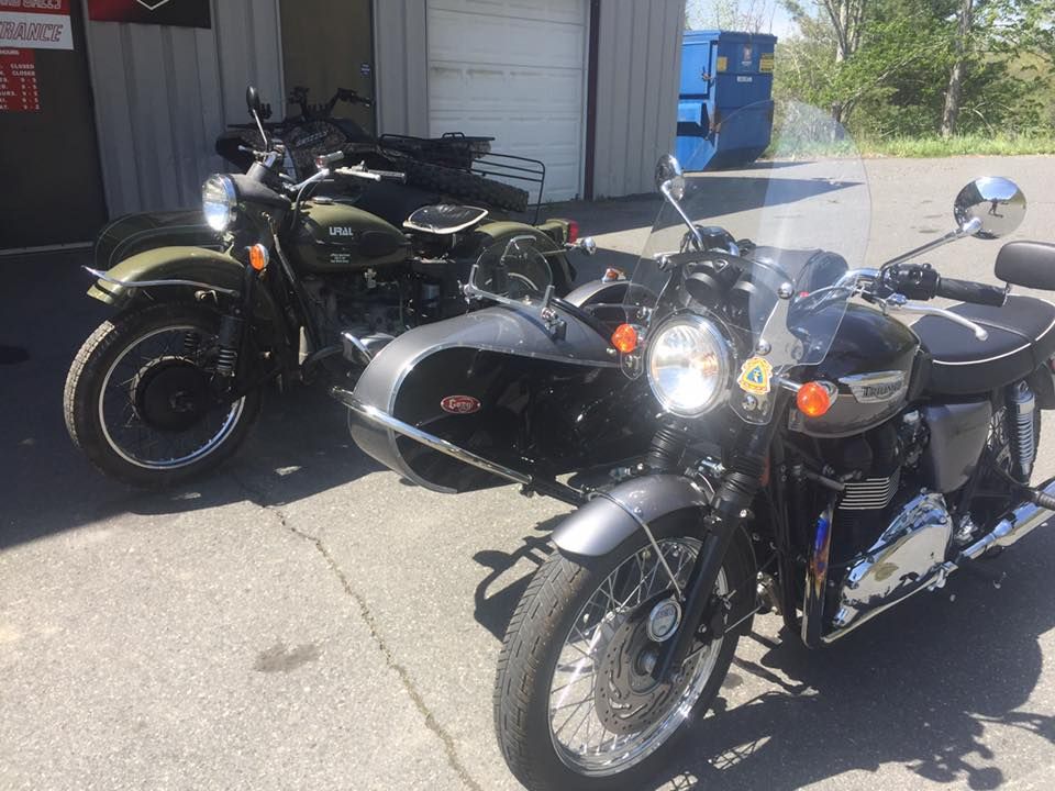 Three motorcycles are parked next to each other in a parking lot.