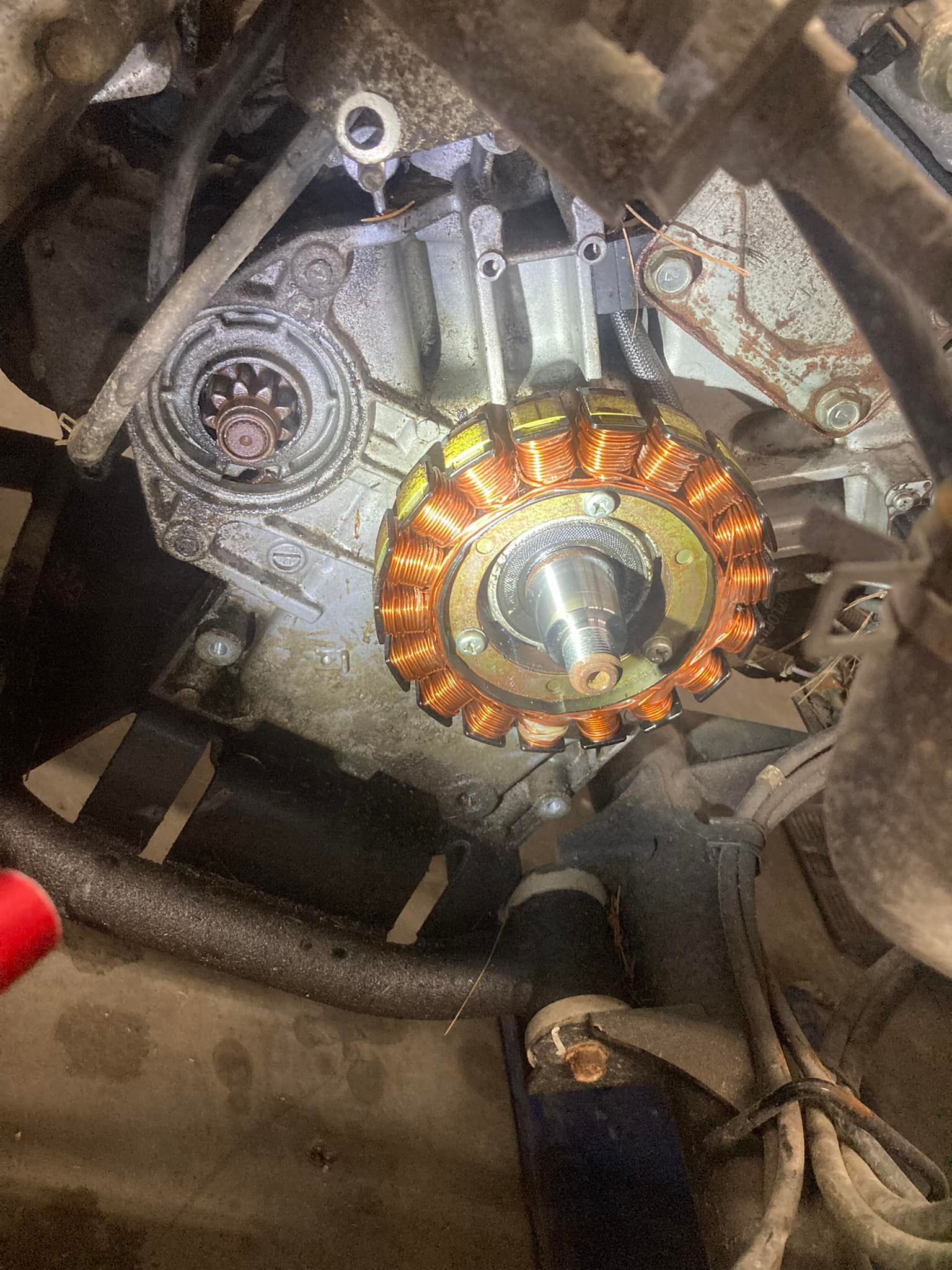 A close up of a motorcycle engine with a stator.