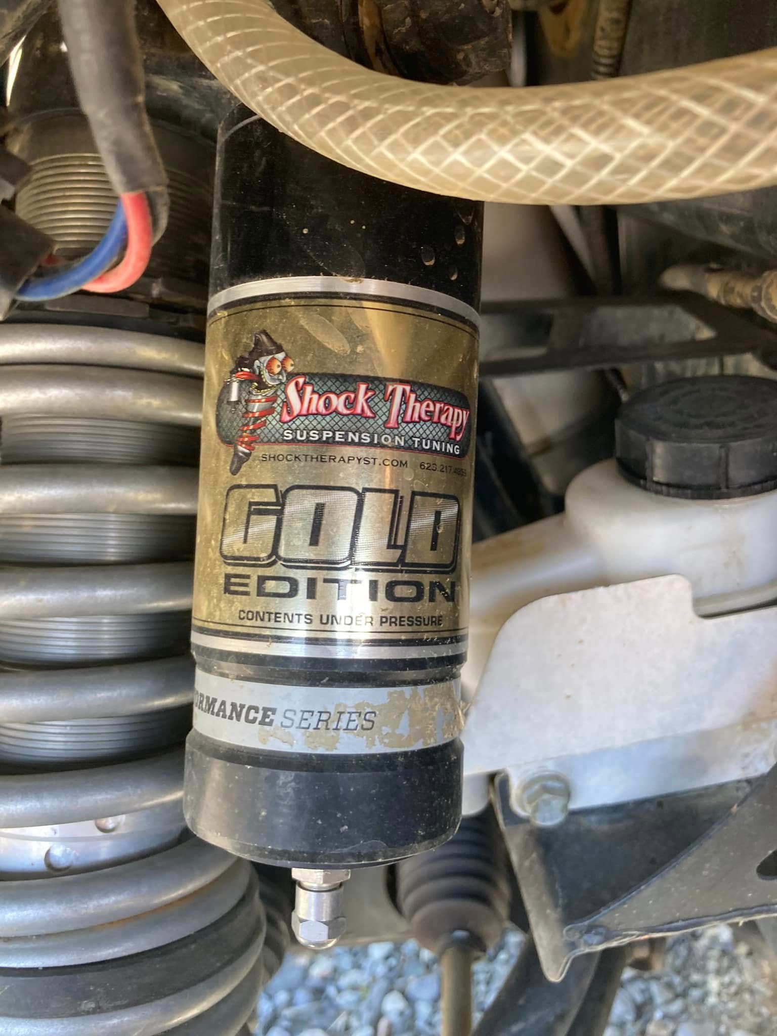A close up of a shock absorber on a vehicle.