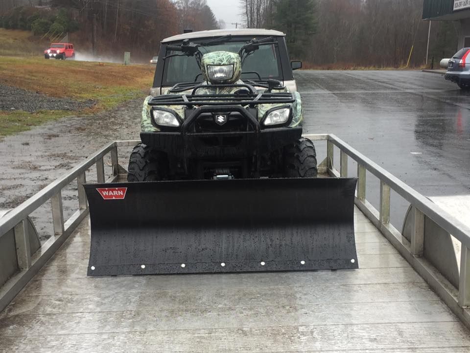 An atv with a plow attached to it
