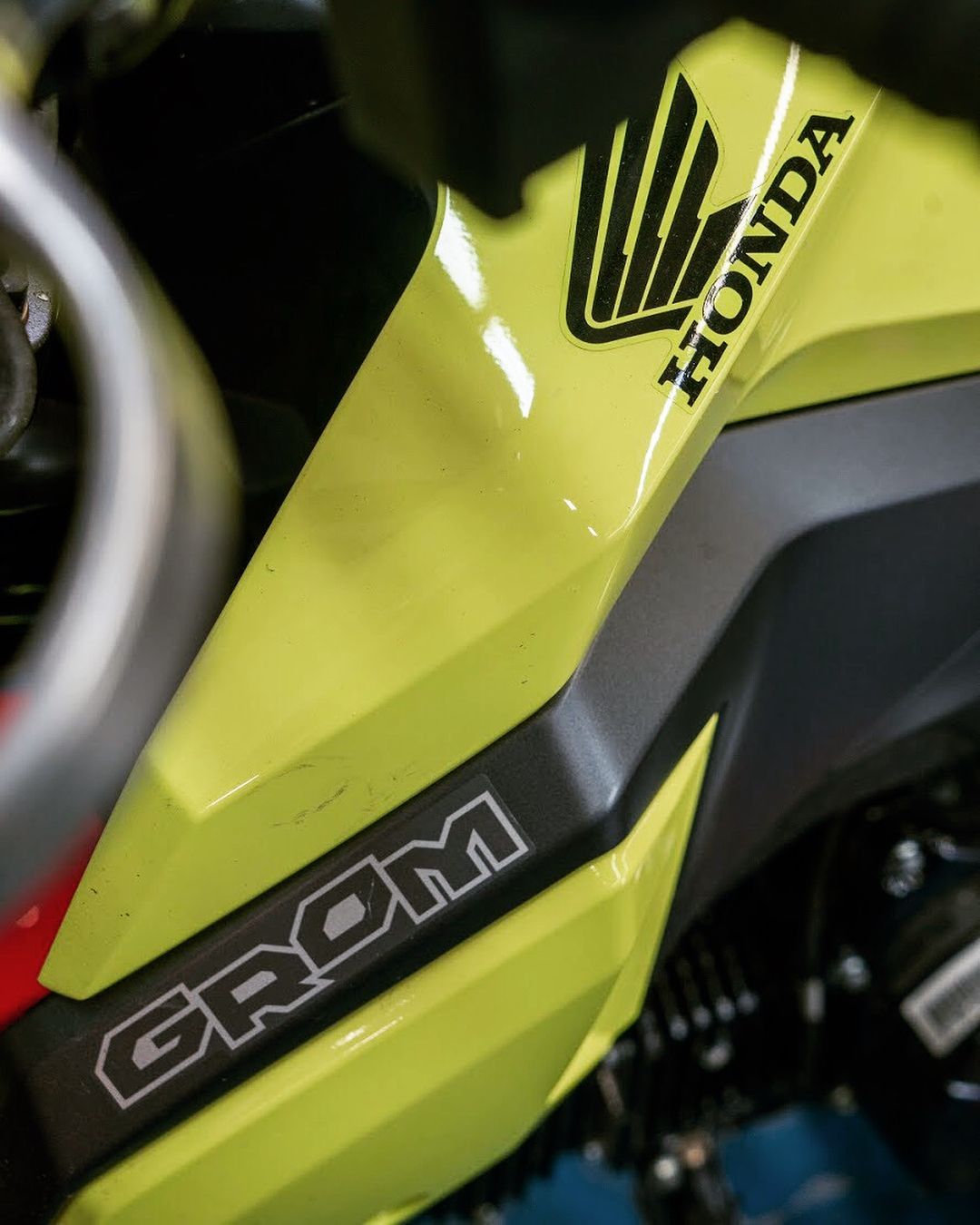 A yellow honda motorcycle with the word grom on the side