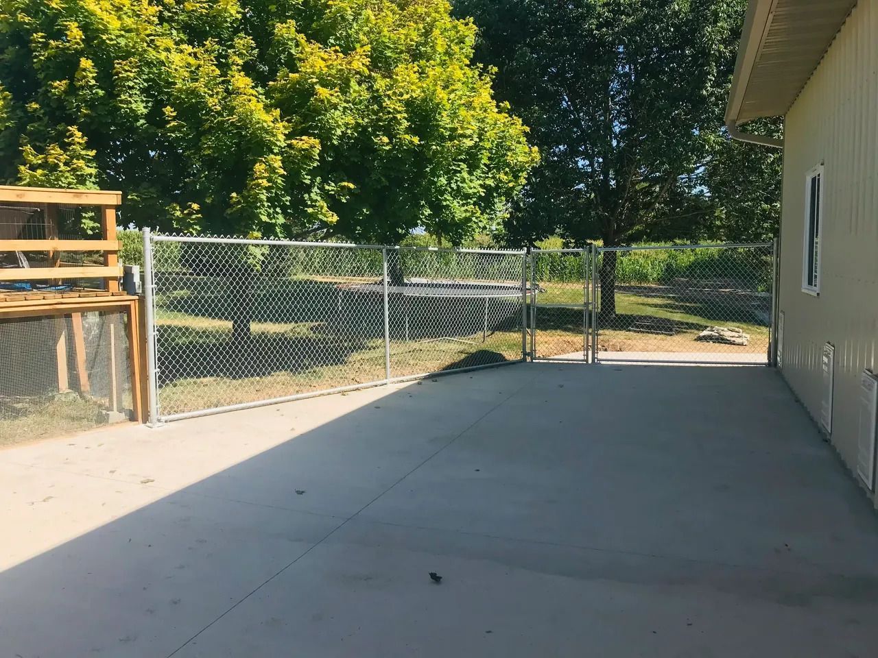 Chain Link Fence Surrounds a Concrete Driveway — Bondurant, IA — Titan Fence LLC