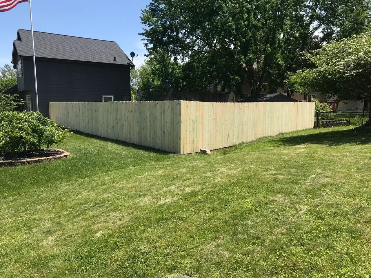 Green Yard with wooden Fence — Bondurant, IA — Titan Fence LLC
