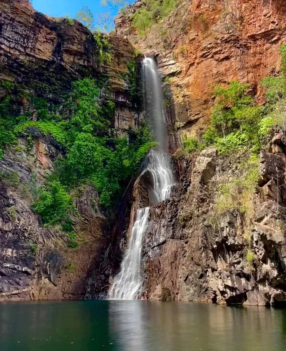 Waterfall Cascading Down a Cliff Face Into a Dark Pool of Water — Litchfield VIP Tours In Darwin City, NT
