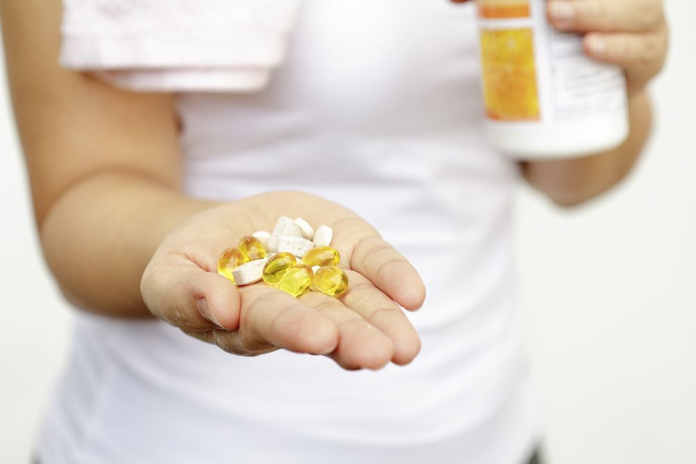 Woman hand With Vitamins And Medication — Personal Medication Packs in Wulguru, QLD