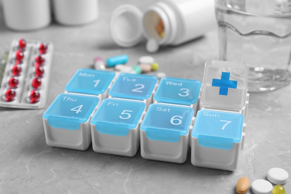 Pill Box With Medicaments On Grey Marble Table — Personal Medication Packs in Wulguru, QLD