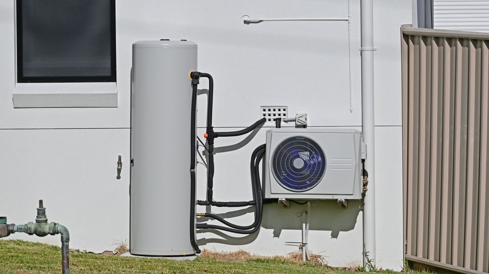 Outdoor Hvac Unit and Tall Gray Tank — Anthony Cameron Electrical & Solar In Kepnock, QLD