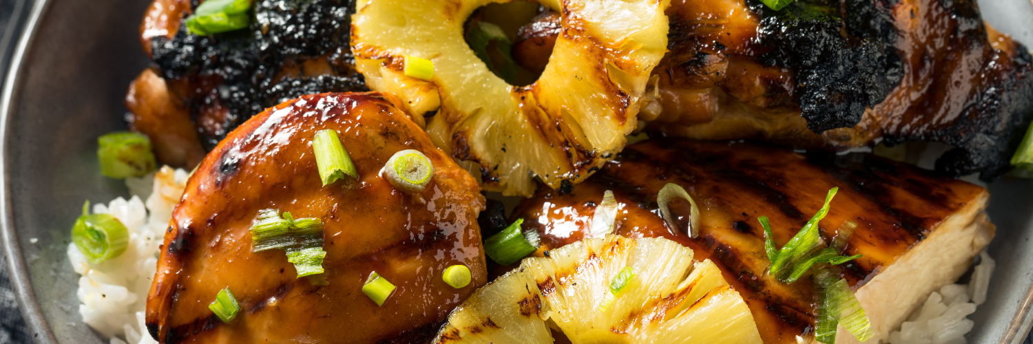 A close up of a plate of food with pineapple and rice.
