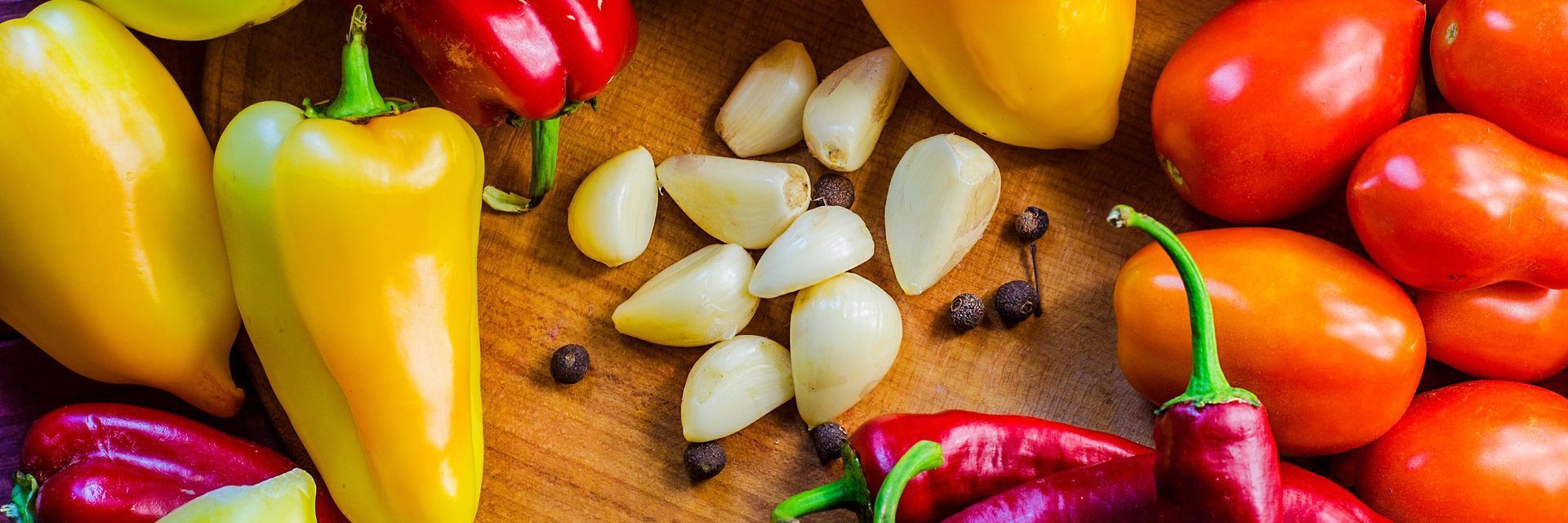 There are many different types of peppers and tomatoes on the table. There are many different types of peppers and tomatoes on the table.