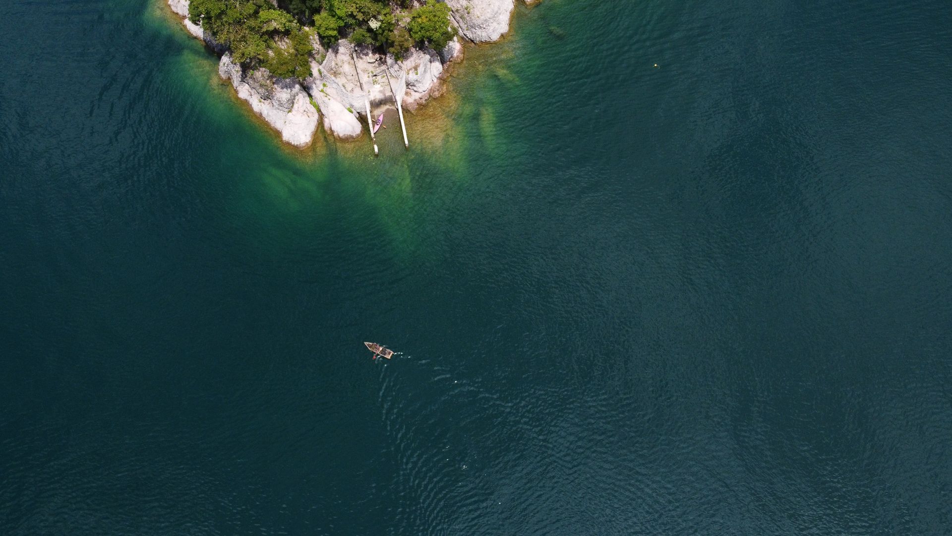 An aerial view of a small island in the middle of a lake.