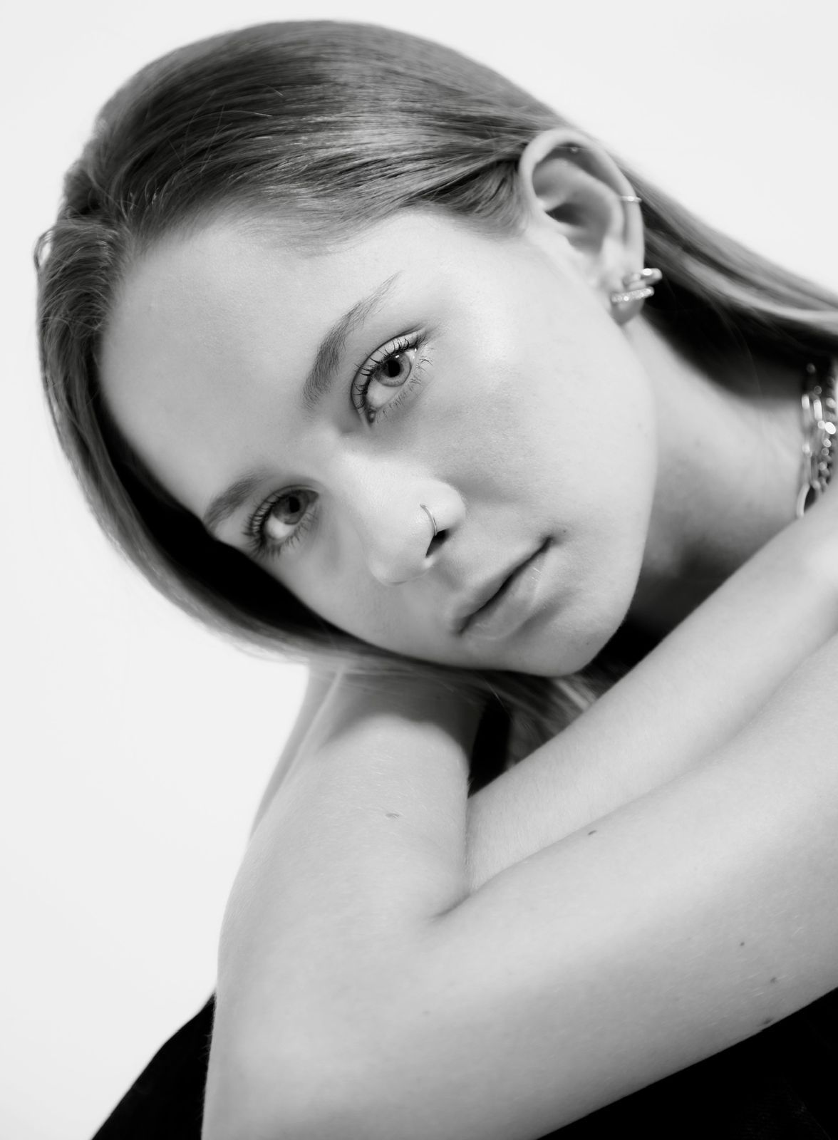 A black and white photo of a woman with a nose ring