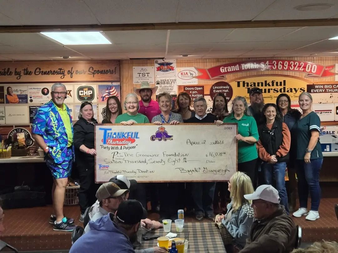 Cheyenne Greenway Foundation members and Thankful Thursday host and sponsors with a ceremonial check for $16,078.