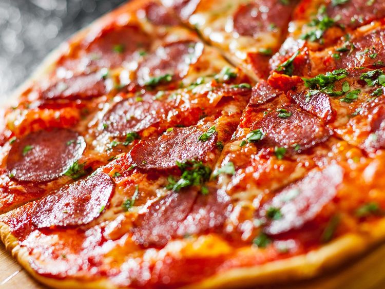 Close-up of sliced pepperoni pizza.