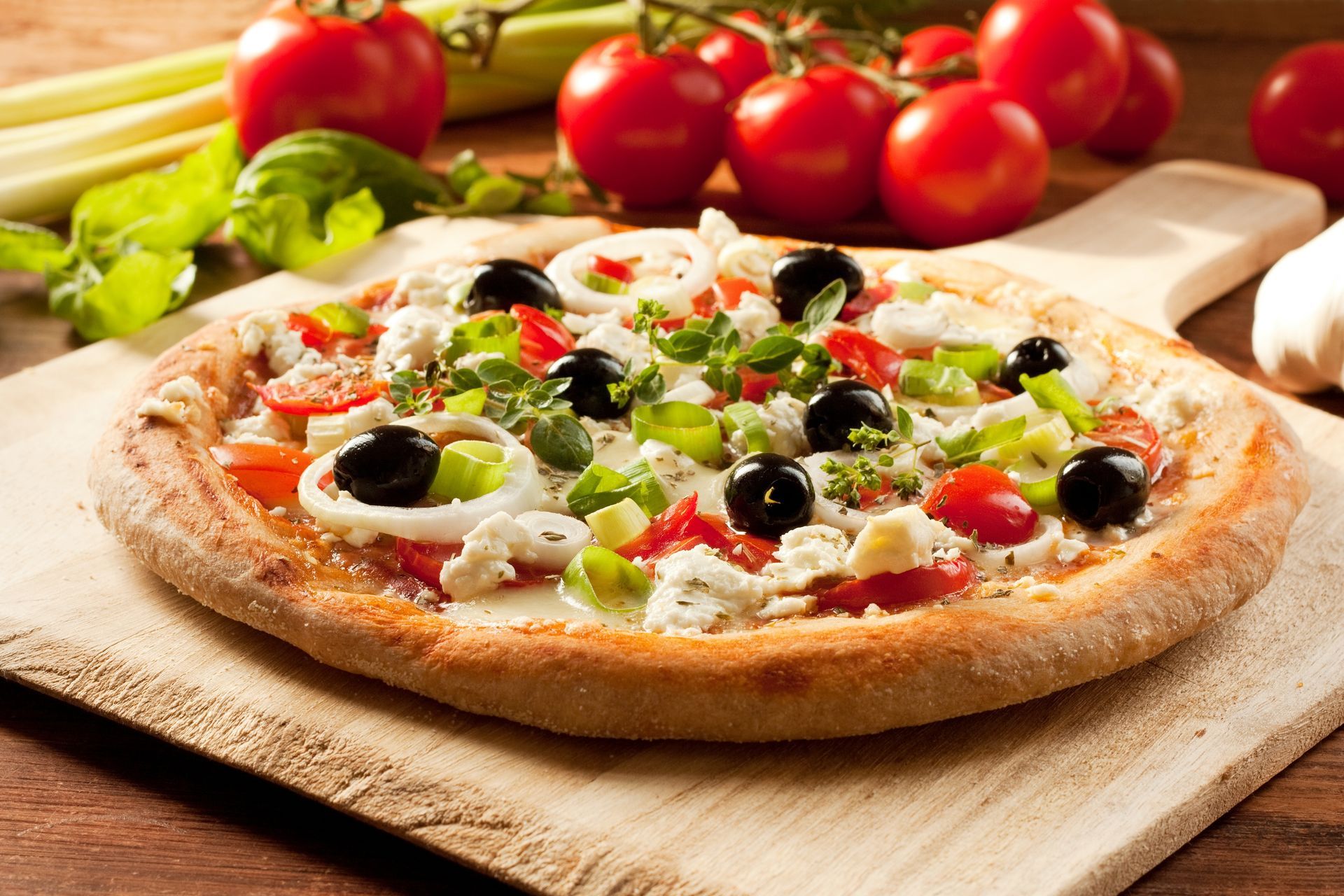 Fresh Greek pizza with olives and feta cheese, a signature dish at our local pizza restaurant.
