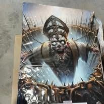 Grim monster face with glowing eyes and open mouth, bursting through a cracked metallic surface.