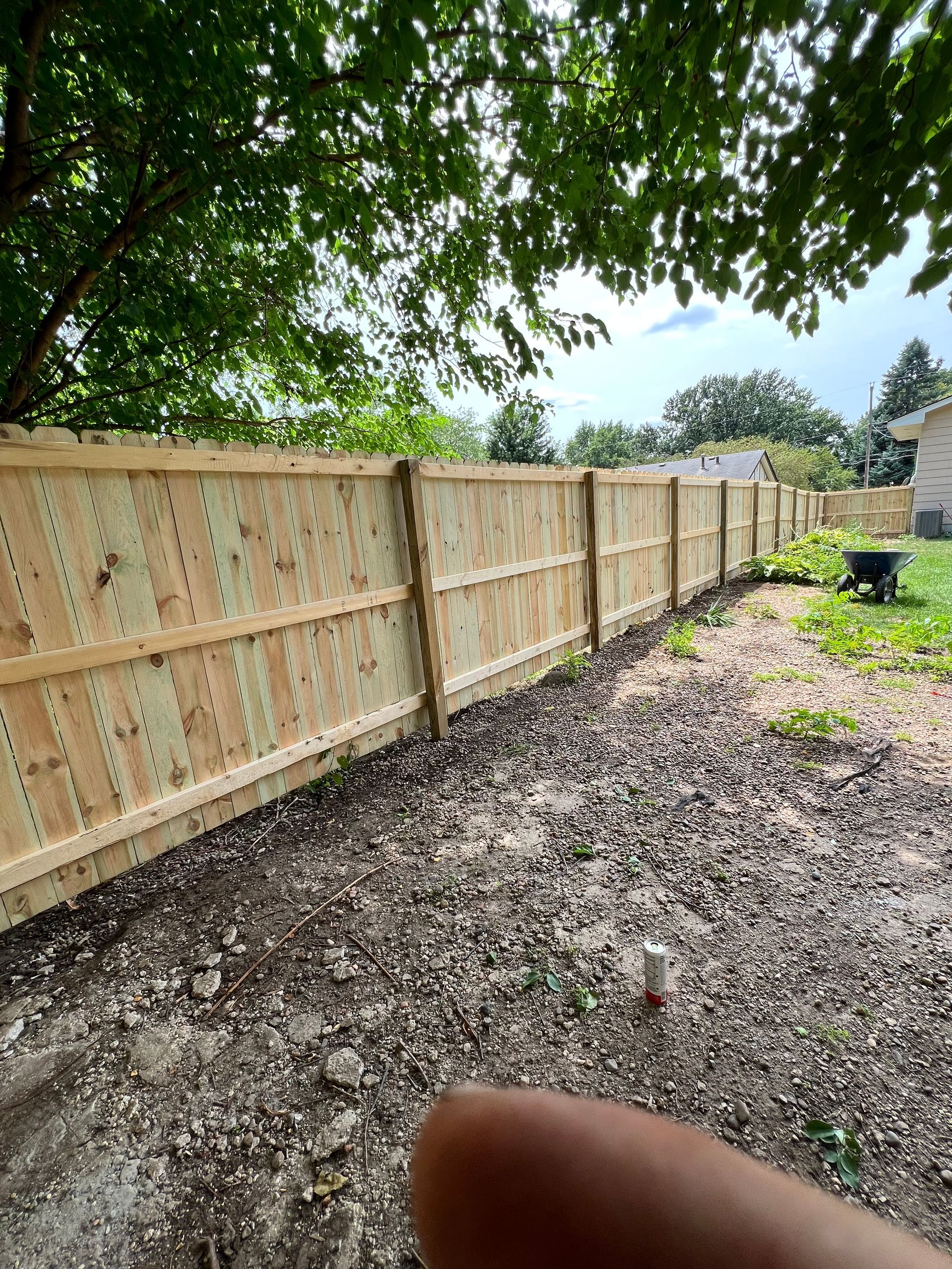 Cedar wood privacy fence installed on a residential property by CD’s Lawn Care in Central Iowa