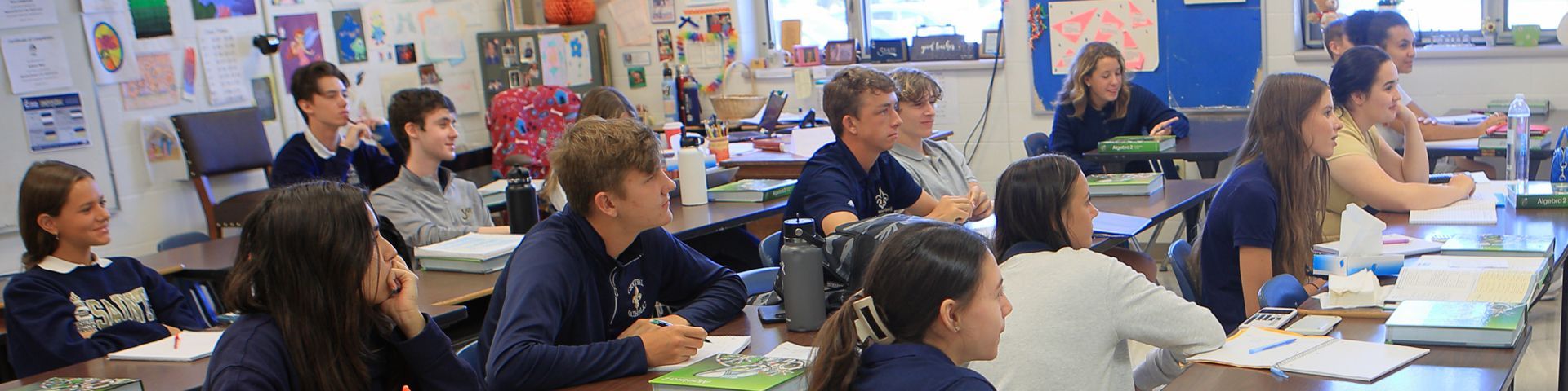 A group of children are sitting at desks in a classroom.