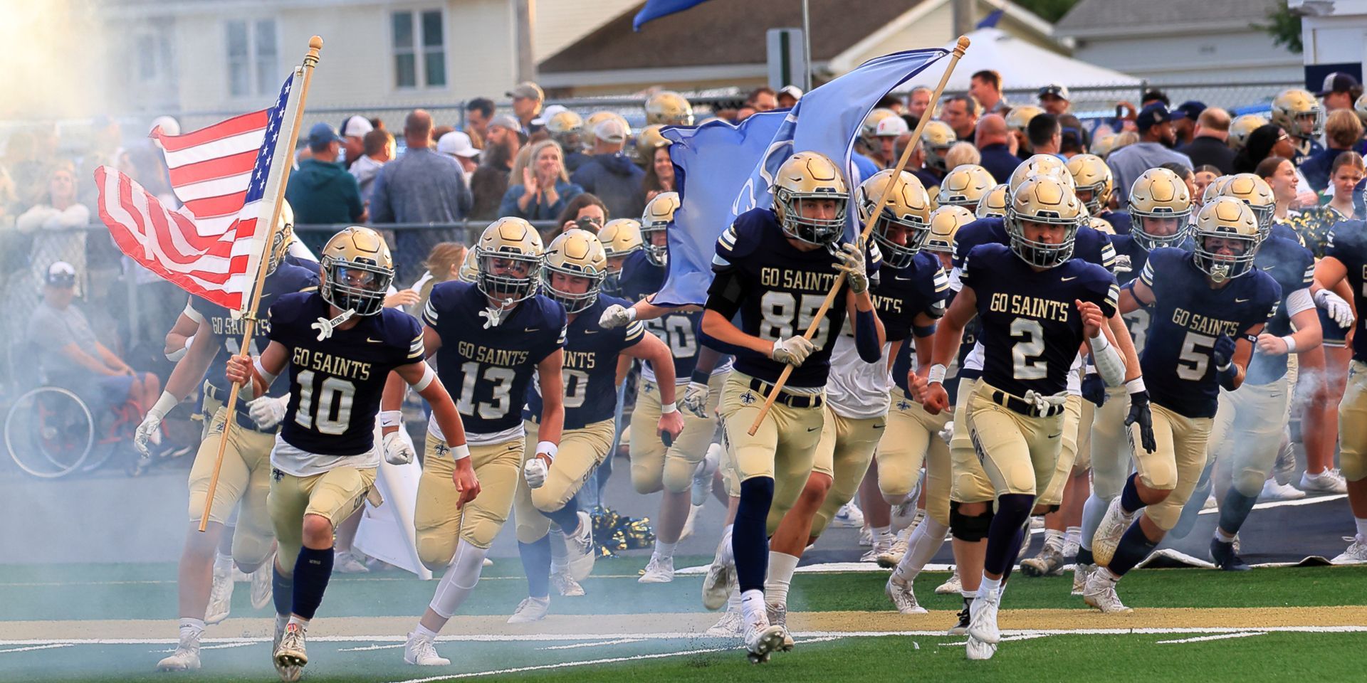 A group of football players are running on a field.