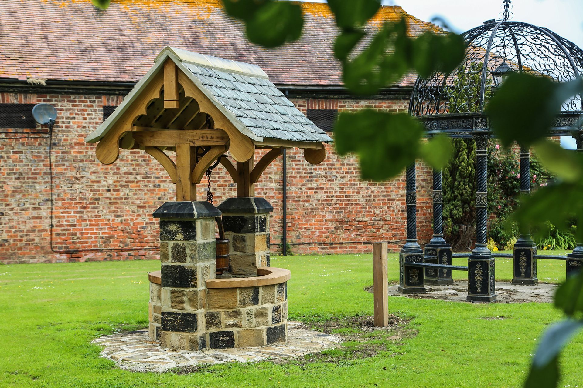 Restored historic stone well in the gardens at Nunthorpe Hall care home
