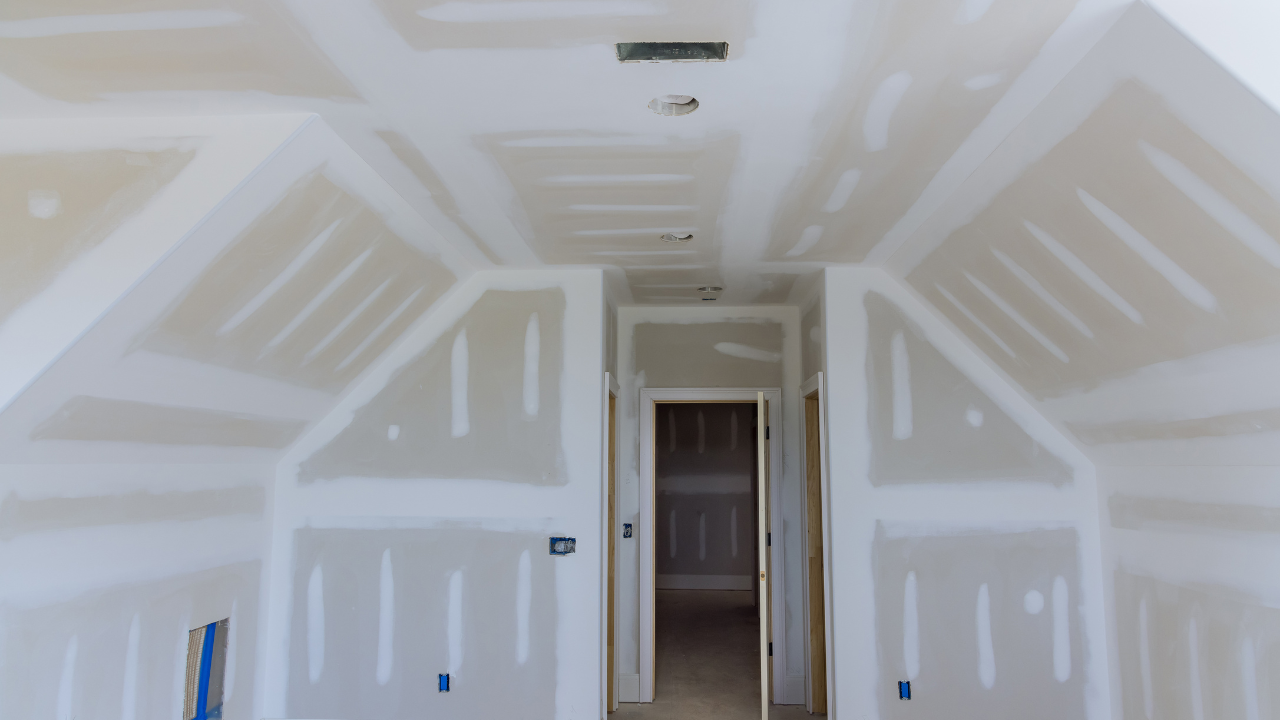 Interior with drywall on walls and ceiling, room under construction.
