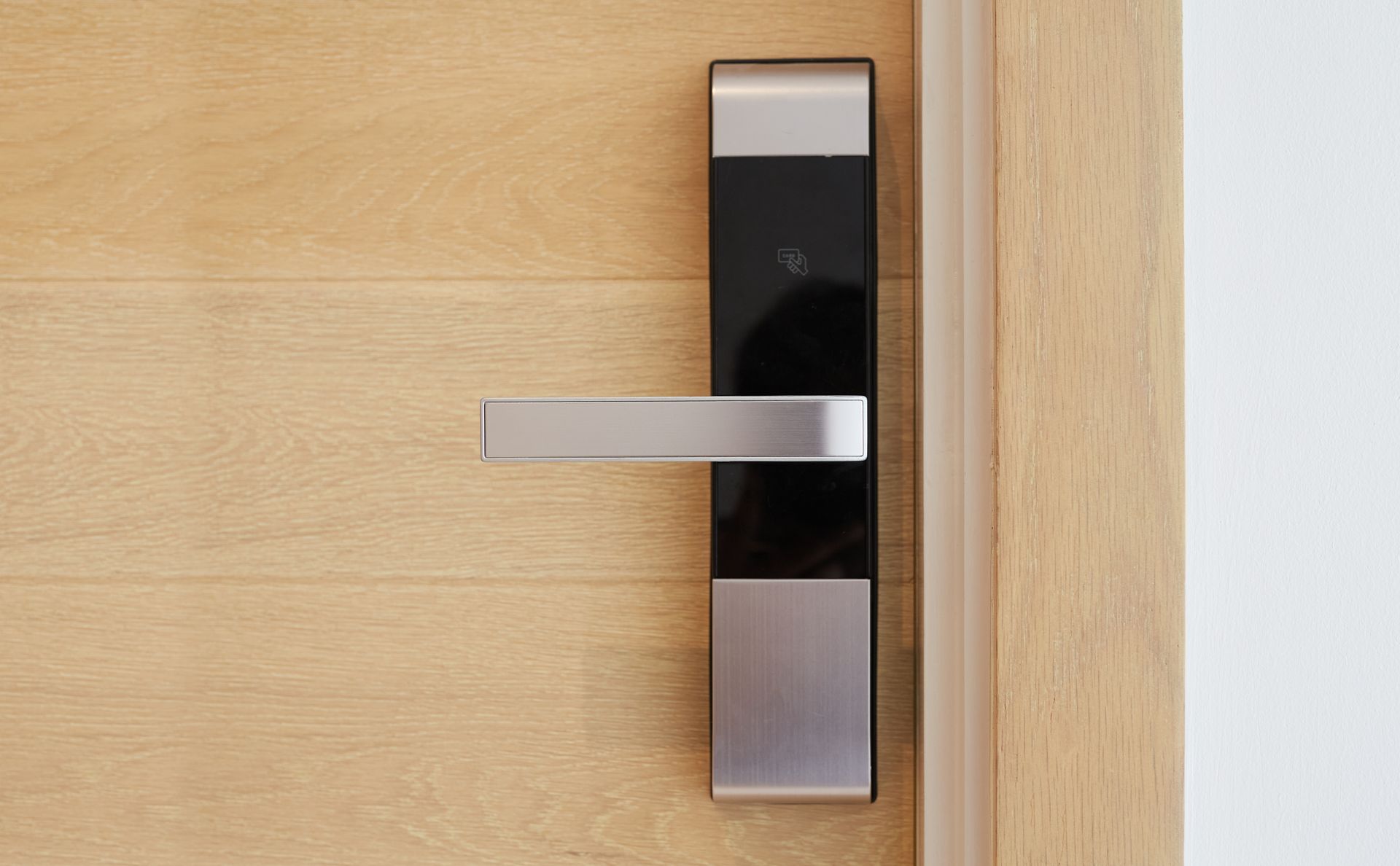 Modern Door Handle on a Light Wooden Door — Yamba Locksmiths in Yamba, NSW
