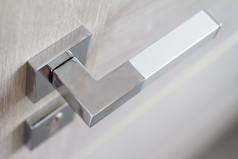Silver Door Handle on a Light-colored Wooden Door — Yamba Locksmiths in Clarence Valley, NSW