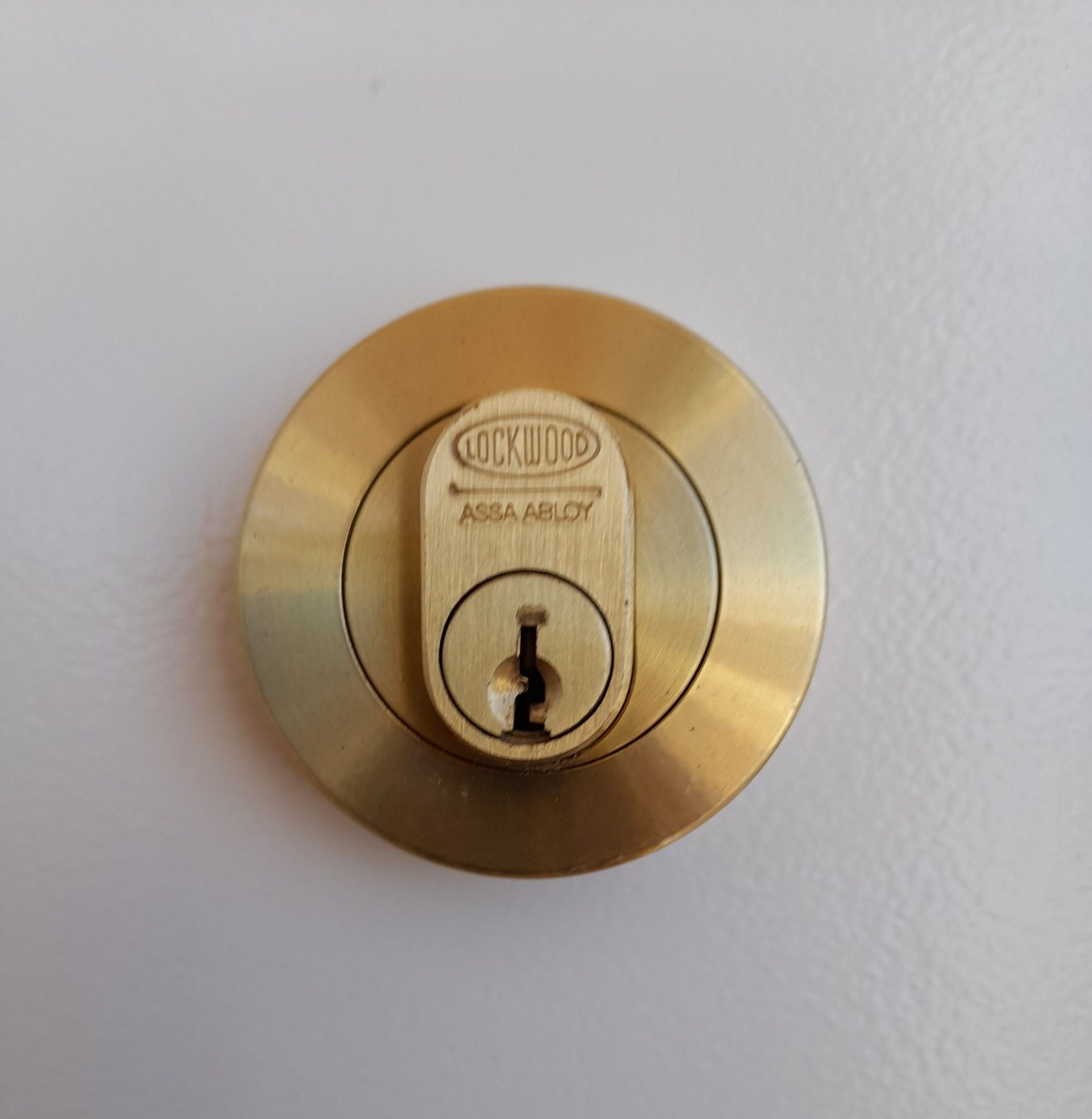 Person Wearing Work Gloves, Installing a Door Lock With a Screwdriver — Yamba Locksmiths in Yamba, NSW