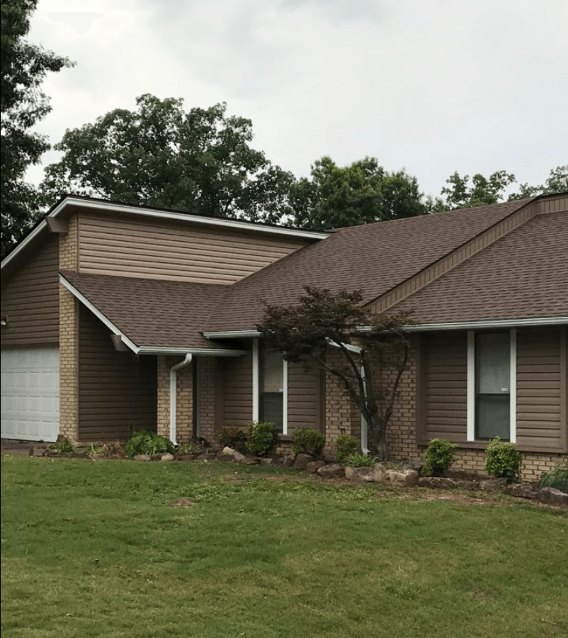 A house with a brown roof and a white garage door