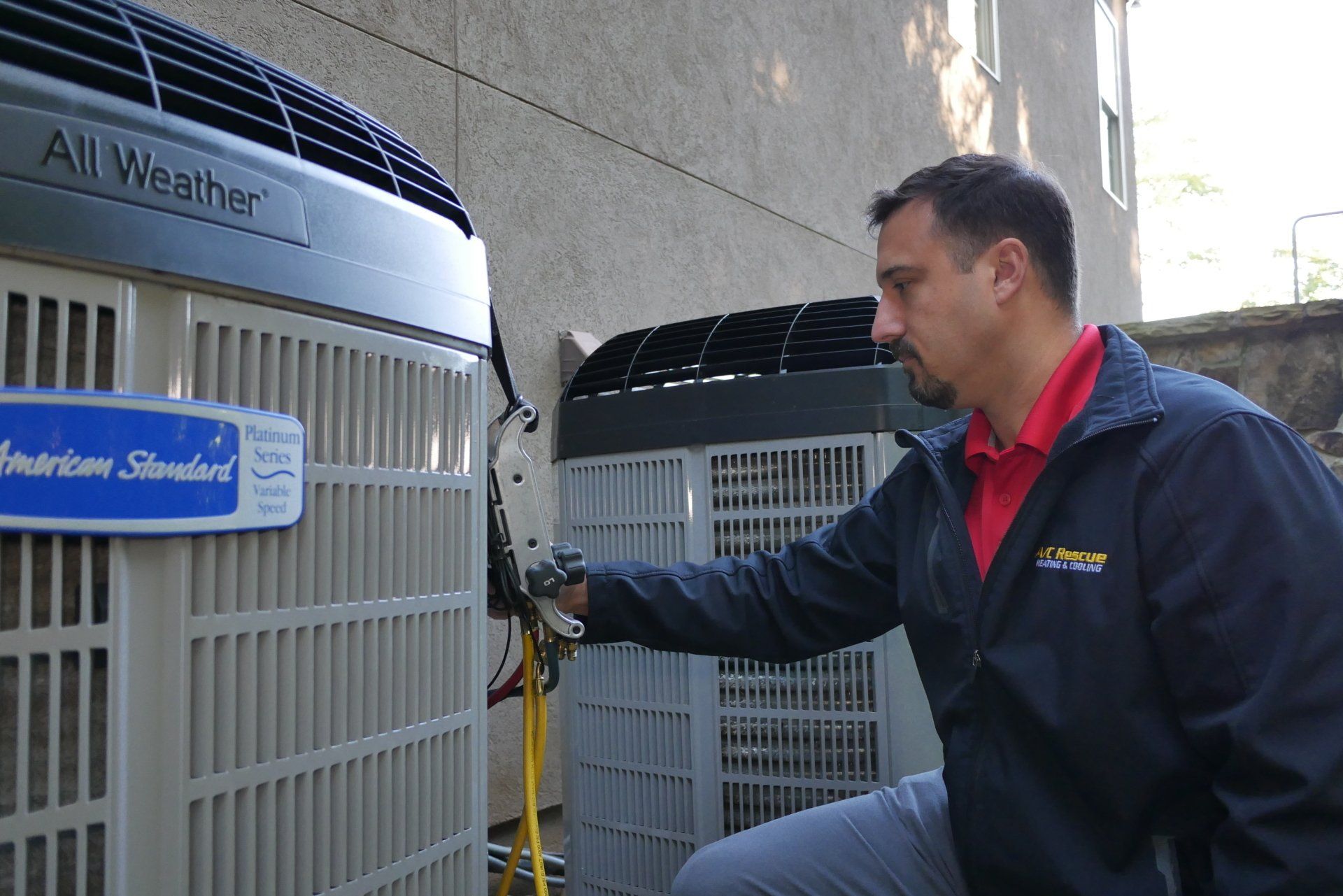 Technician inspecting large industrial cooling units outdoors