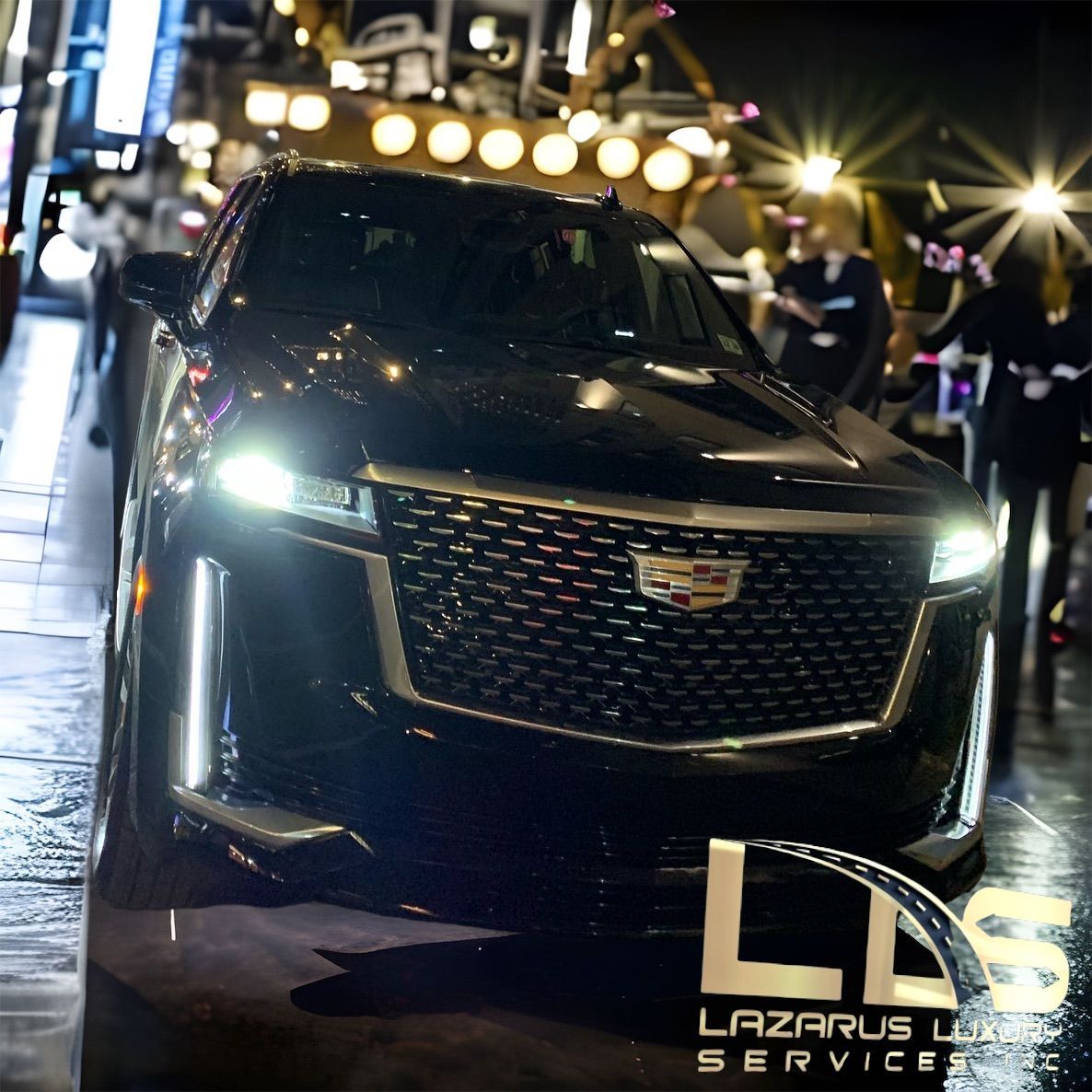 A black car is parked on the side of the road and says lazarus luxury services