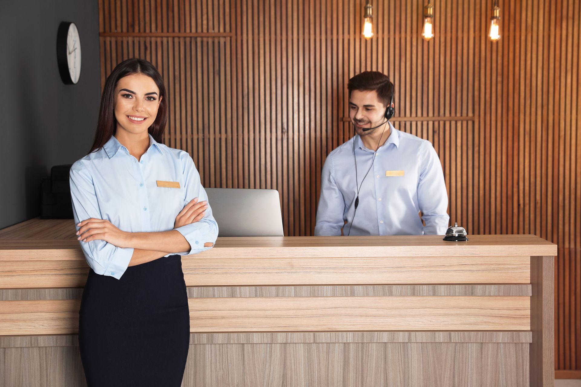 A Man Is Talking On A Phone While A Woman Smiles At The Camera