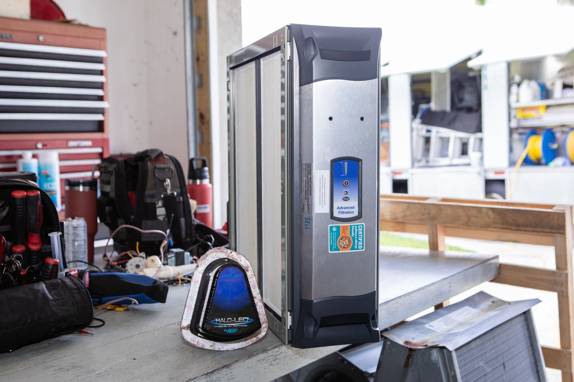 Close-up of two glowing purple plasma tubes in a dark setting, with electrical arcs inside.