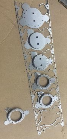 Metal cutouts on a tan surface.