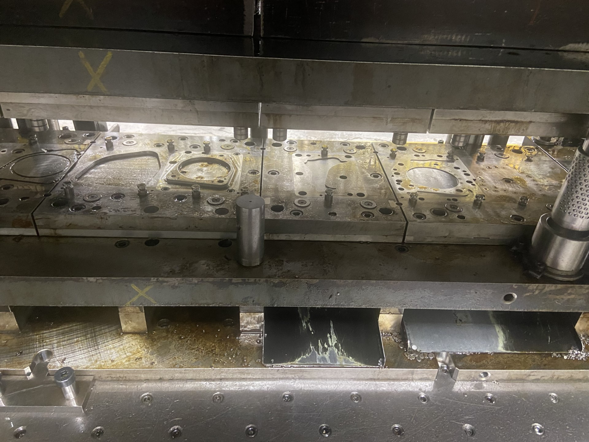 Metal stamping machine with dies in use.