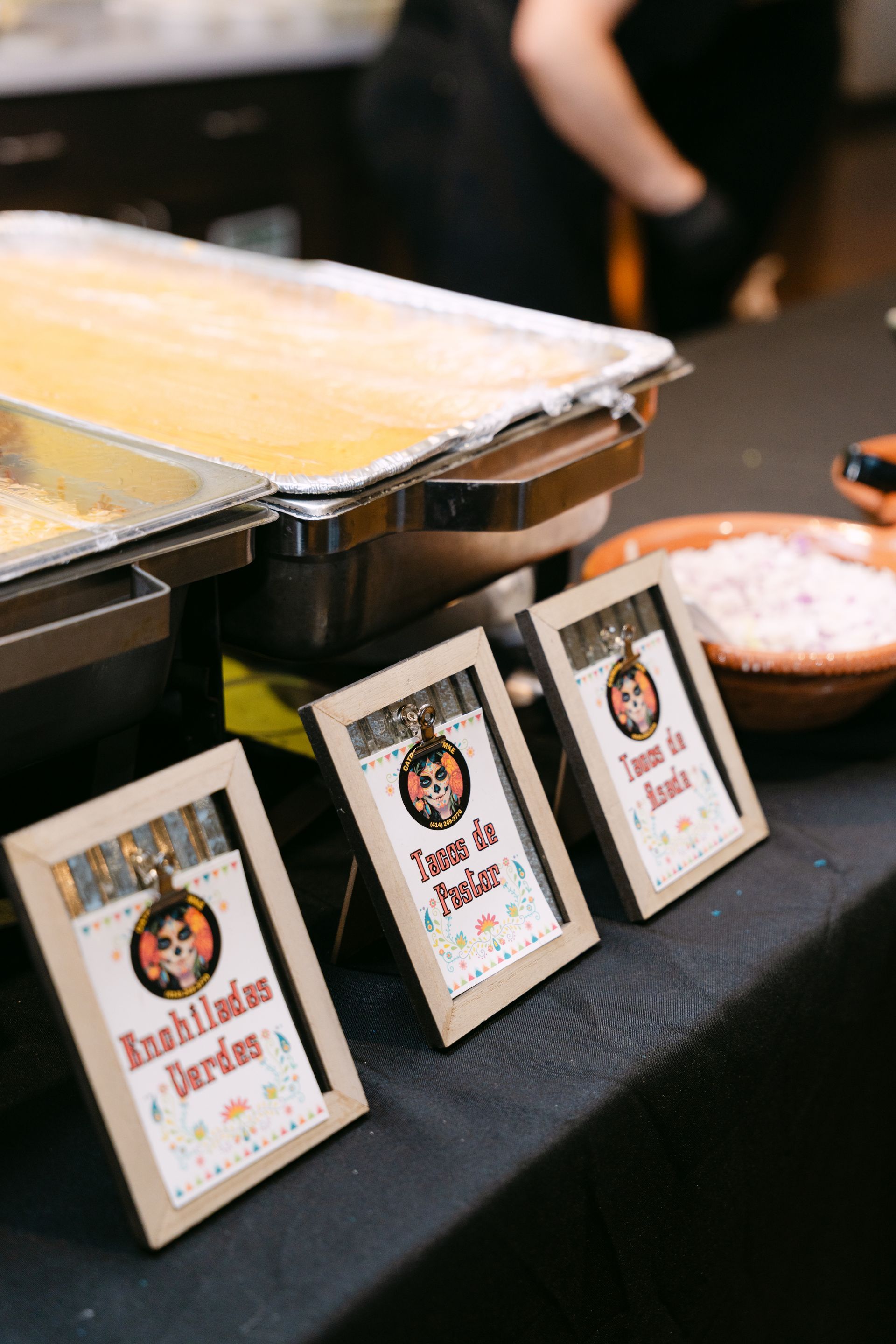 Food buffet with signs for Enchiladas, Tacos, and toppings.
With Love, Wedding management, Milwaukee Wedding Coordinator