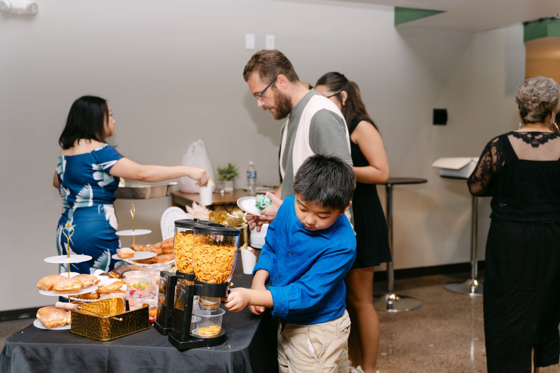 People at a buffet table, one child reaching. Snacks and drinks are on the table.
With Love, Wedding management, Milwaukee Wedding Coordinator