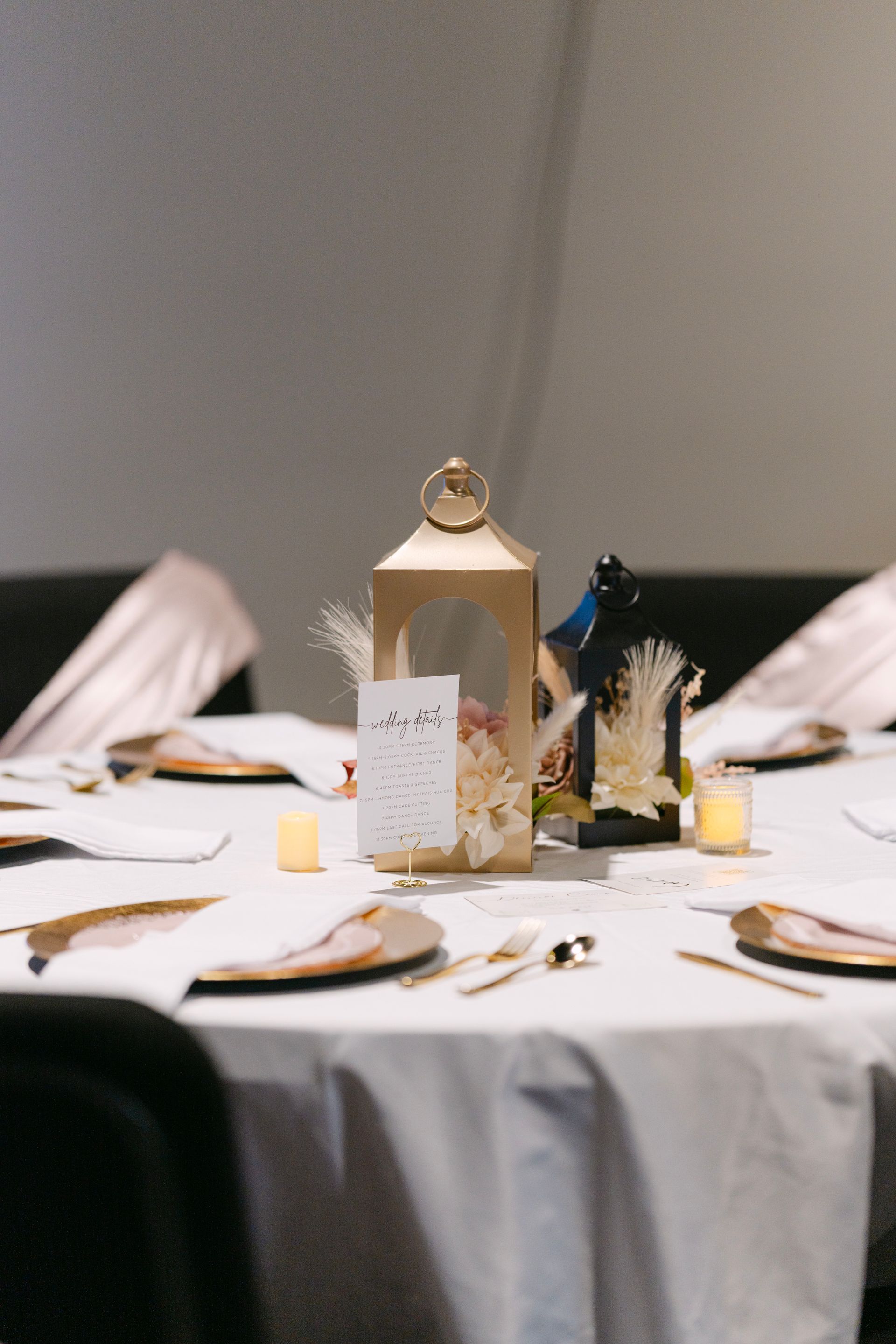 Table setting with gold accents, lanterns, and place cards on a white tablecloth.
With Love, Wedding management, Milwaukee Wedding Coordinator